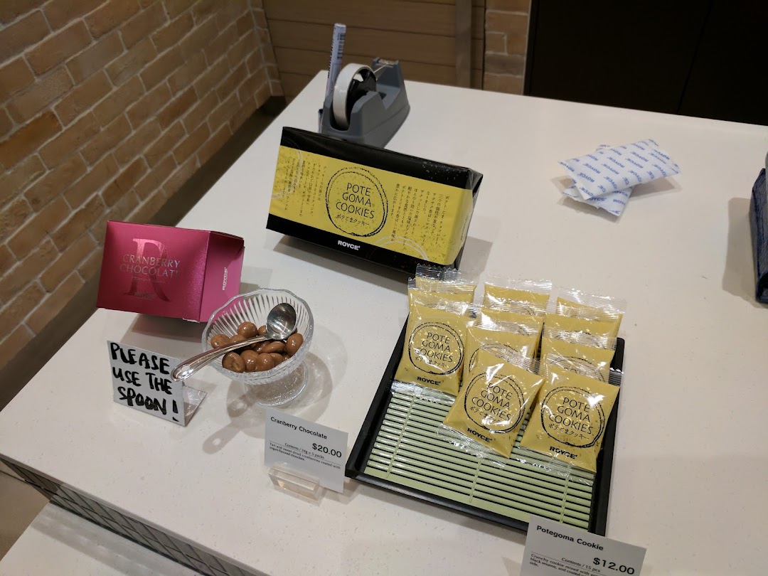 A display counter at Royce featuring Cranberry Chocolate and Potegoma Cookies, with a sample bowl.