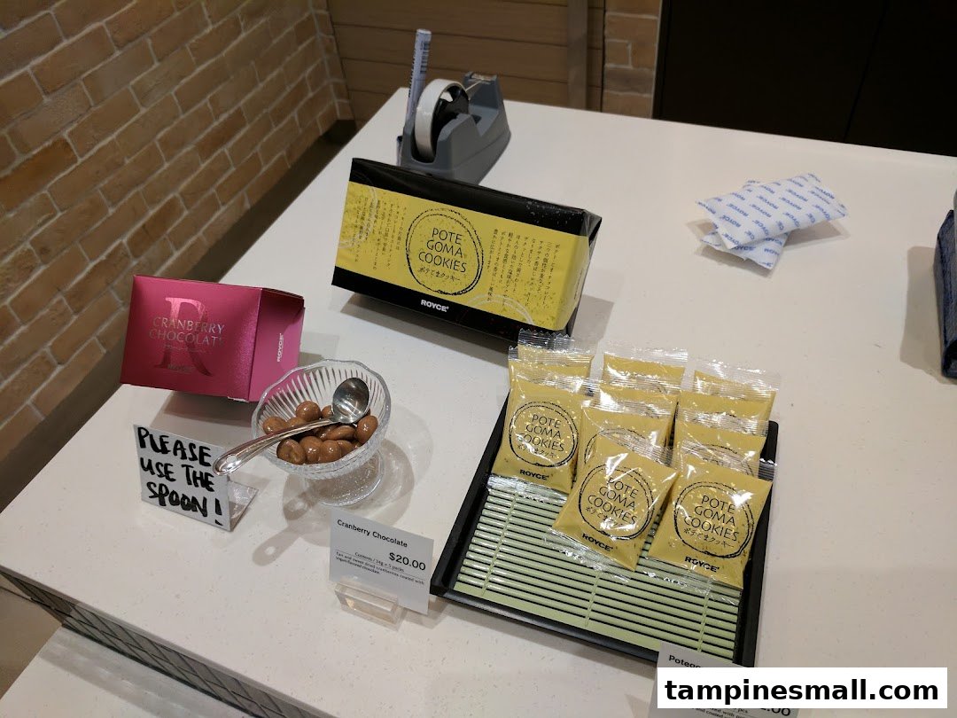 A display counter at Royce featuring Cranberry Chocolate and Potegoma Cookies, with a sample bowl.