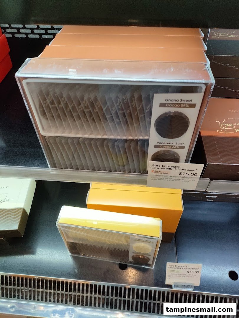Assorted Royce Pure Chocolate varieties displayed in clear packaging with price tags.