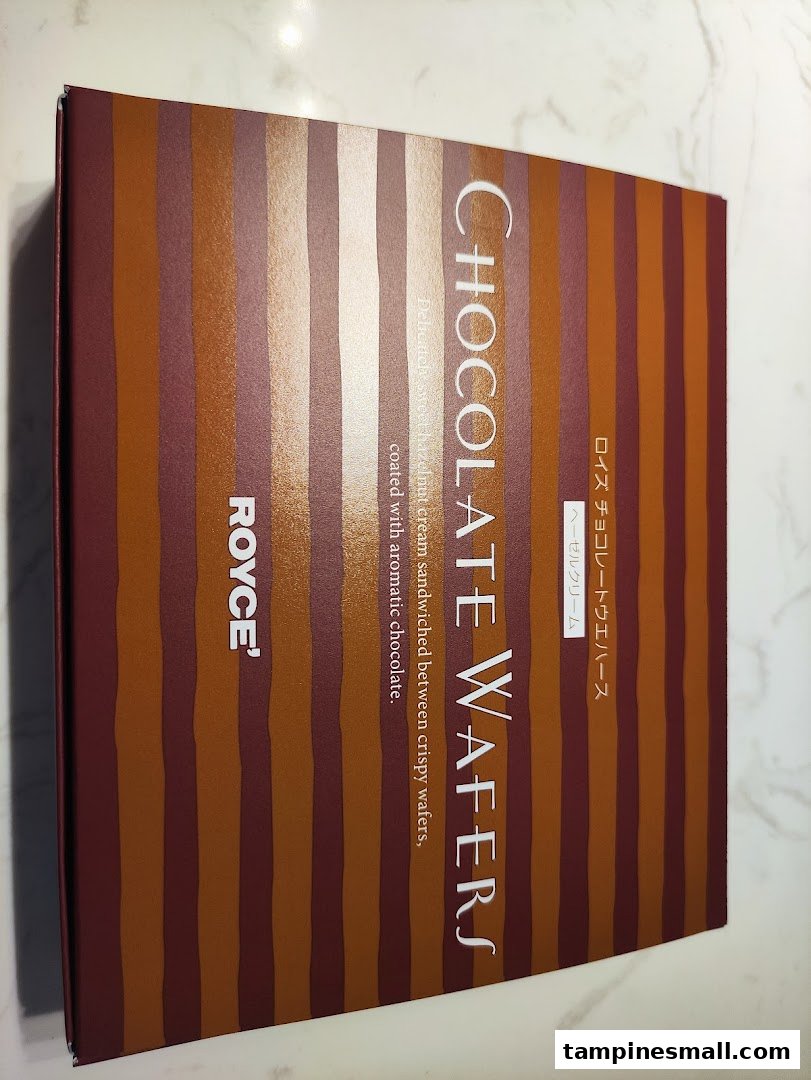 A box of Royce' Chocolate Wafers, featuring a striped design and product details.
