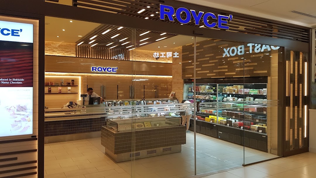 The storefront of Royce, a premium chocolate shop, showcasing its inviting interior and products.