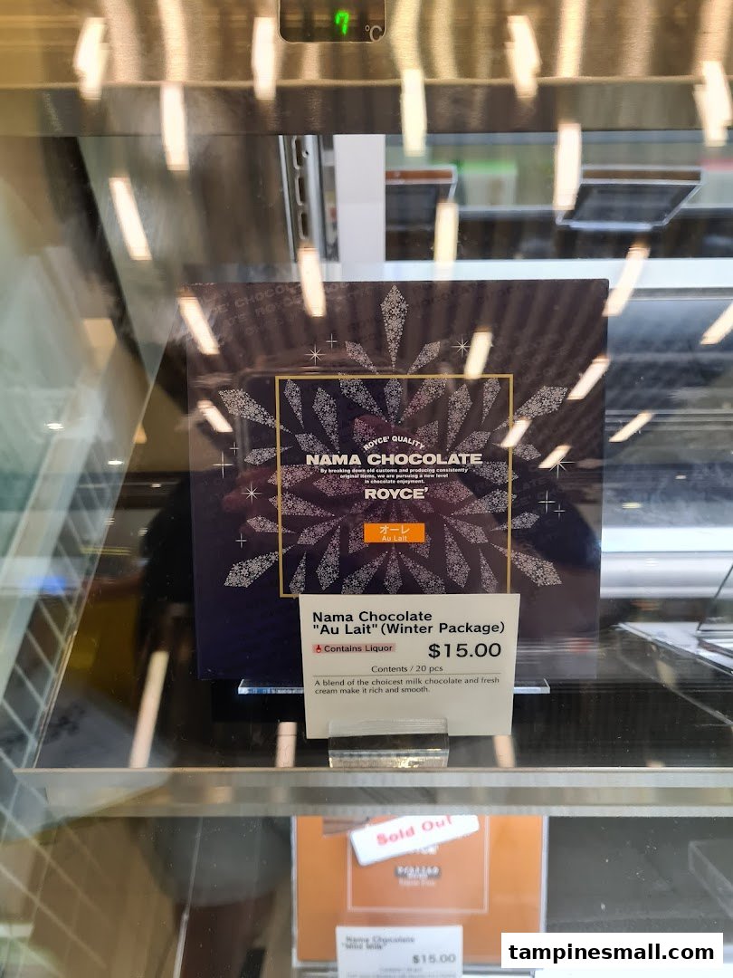A display sign for Royce's Nama Chocolate 'Au Lait' (Winter Package) with price and description.