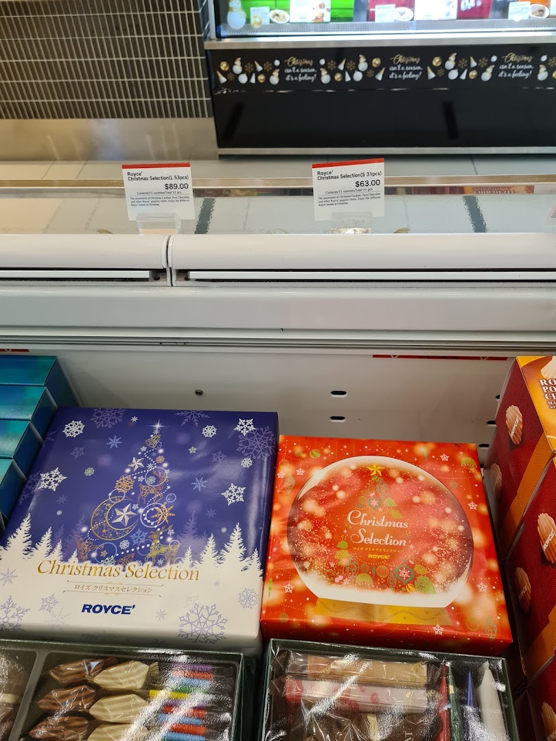 Royce's Christmas Selection chocolate boxes and price tags displayed in a retail case.