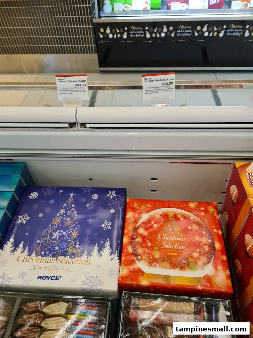 Royce's Christmas Selection chocolate boxes and price tags displayed in a retail case.