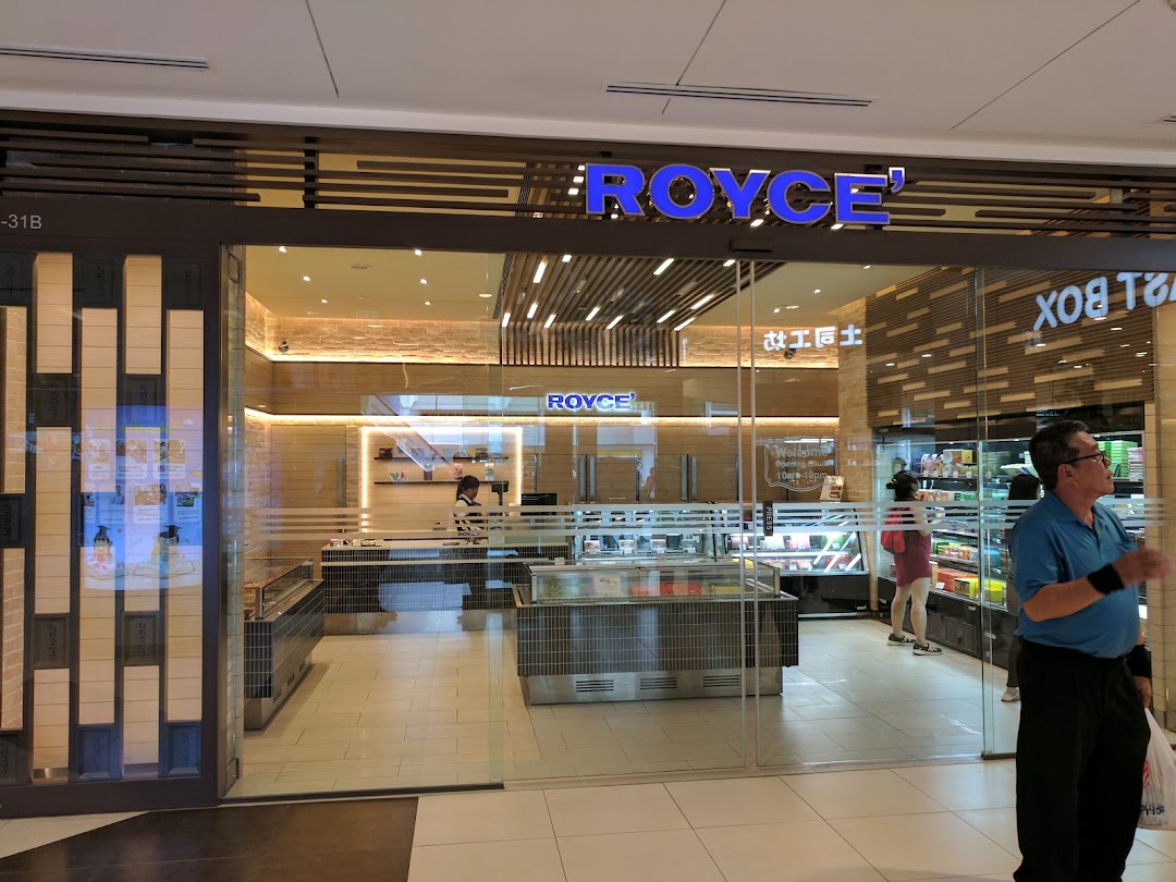 The elegant storefront of Royce, a Japanese chocolate shop, with its name prominently displayed.