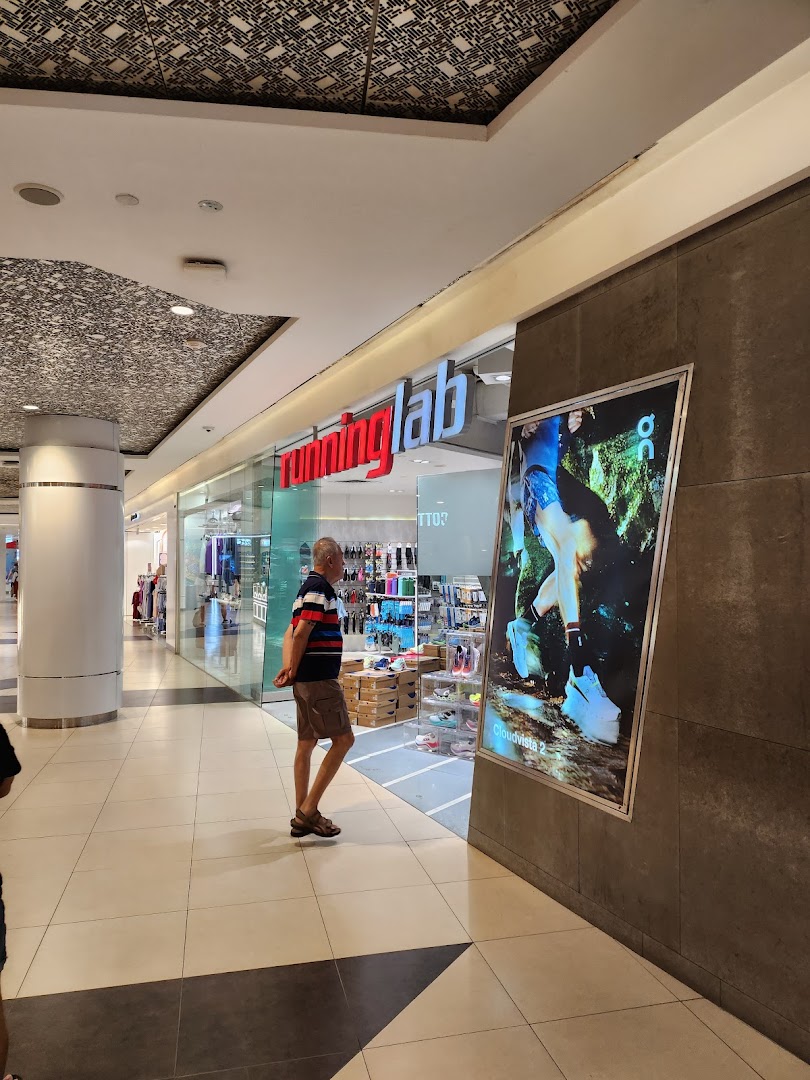 The storefront of Running Lab, a specialty running store, with a large display ad.
