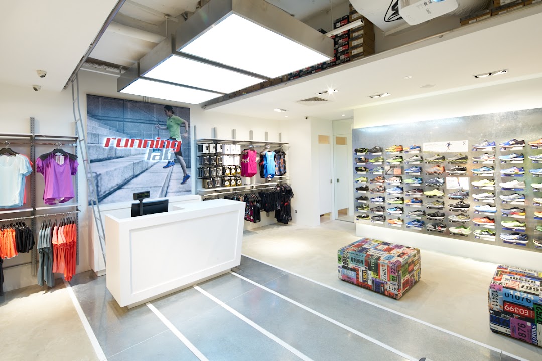 Interior view of Running Lab Tampines, showcasing running shoes, apparel, and a service counter.