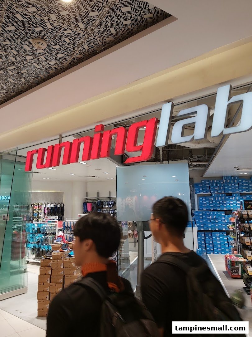 The shop front of Running Lab Tampines, a specialty running store, with two customers walking past.