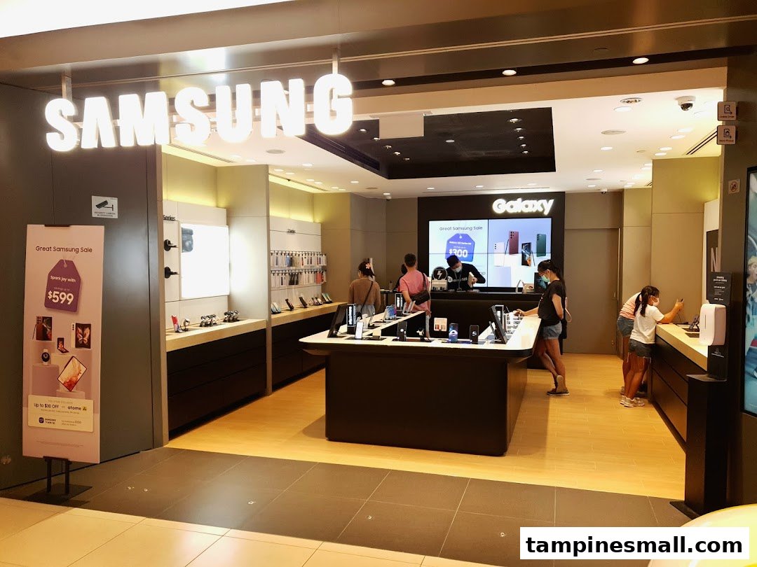 The entrance of a Samsung Experience Store with customers browsing various electronic devices and promotional displays.
