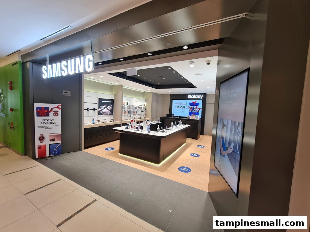 The brightly lit entrance of a Samsung Experience Store, showcasing display tables and promotional signage.
