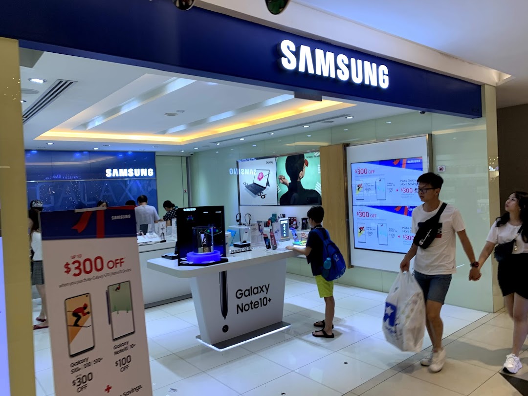 Inside the Samsung Experience Store, customers explore the latest smartphones and electronics amidst vibrant displays and promotions.