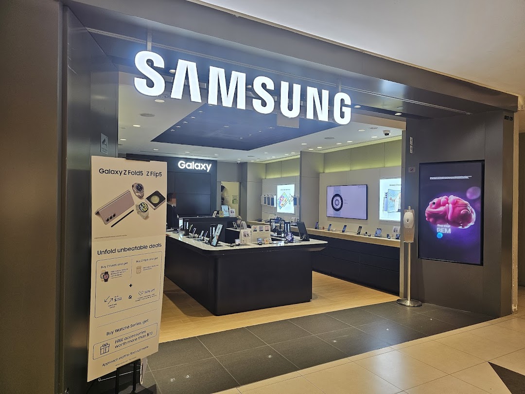 The brightly lit entrance of a Samsung Experience Store showcasing the latest Galaxy devices and promotions.