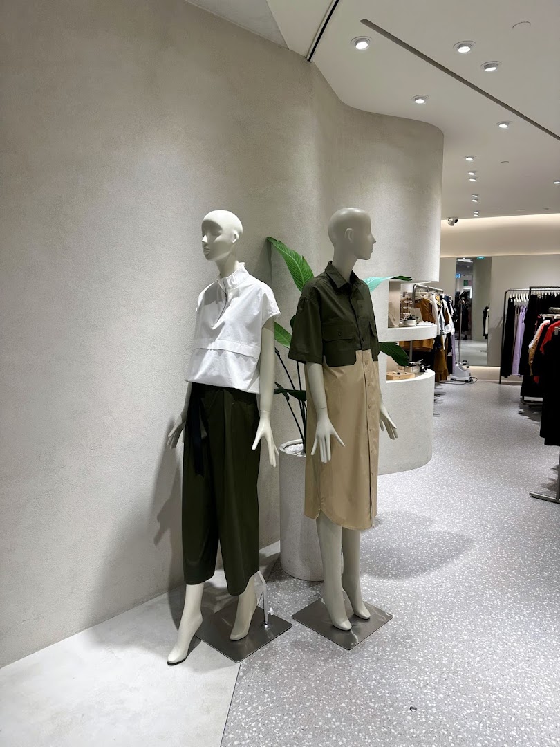 Two mannequins display modern apparel inside SANS SANS, showcasing the latest fashion trends.