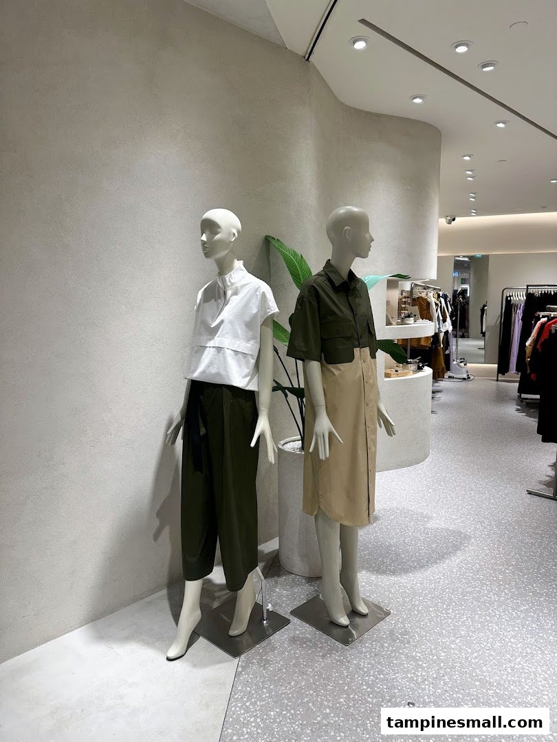 Two mannequins display modern apparel inside SANS SANS, showcasing the latest fashion trends.