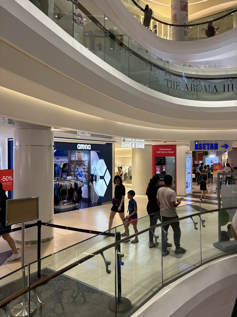 An interior view of Tampines Mall showcasing SANS & SANS and other retail stores.