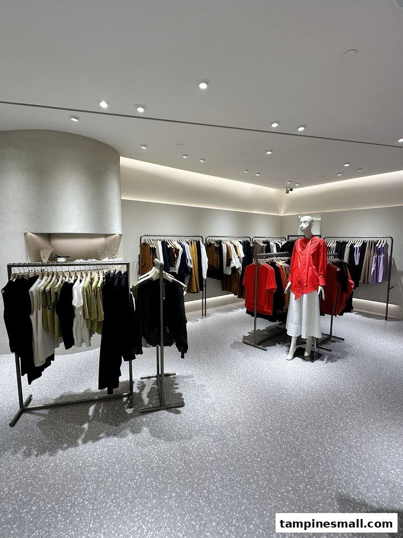 An interior view of SANS SANS clothing store, featuring modern racks of apparel and a mannequin.