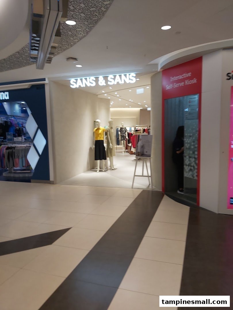 The entrance of SANS & SANS fashion store, featuring mannequins and a nearby interactive self-serve kiosk.