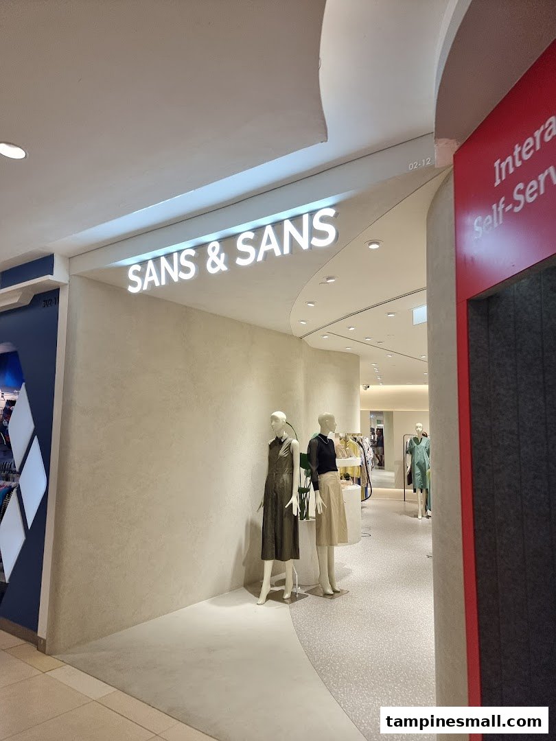 The entrance of SANS & SANS fashion boutique, featuring stylish mannequins and inviting interior.