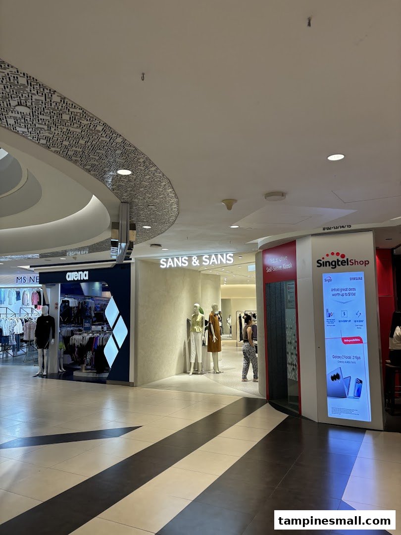 The entrance of SANS & SANS fashion boutique with mannequins and a nearby Singtel kiosk.