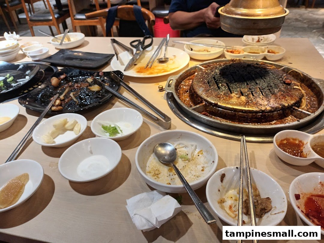 A table at Seorae Jib after a Korean BBQ meal, showing a grill and used dishes.