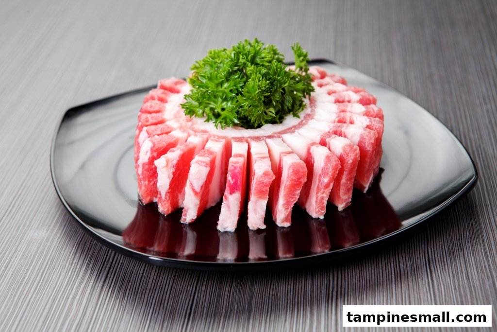 A plate of thinly sliced raw pork belly arranged in a circle with fresh green garnish.