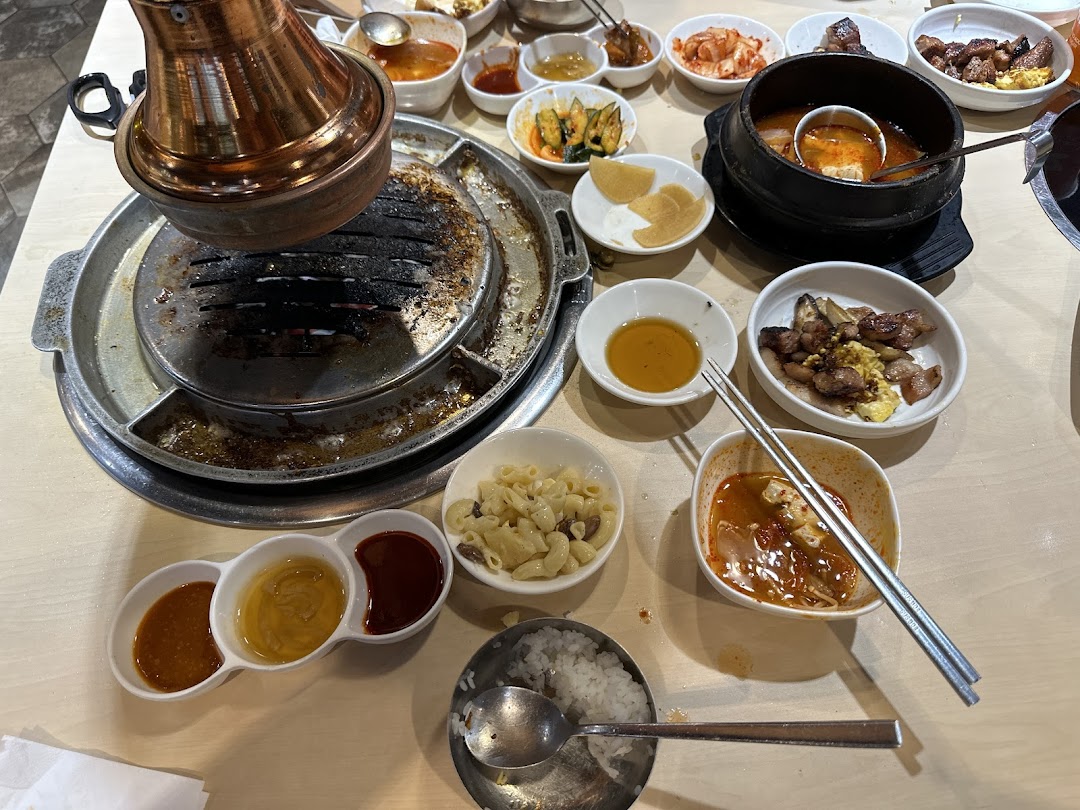 A table laden with delicious Korean BBQ, banchan, and soup, ready for a delightful meal.