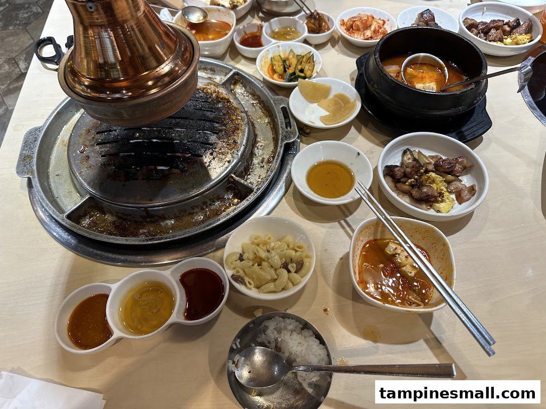 A table laden with delicious Korean BBQ, banchan, and soup, ready for a delightful meal.