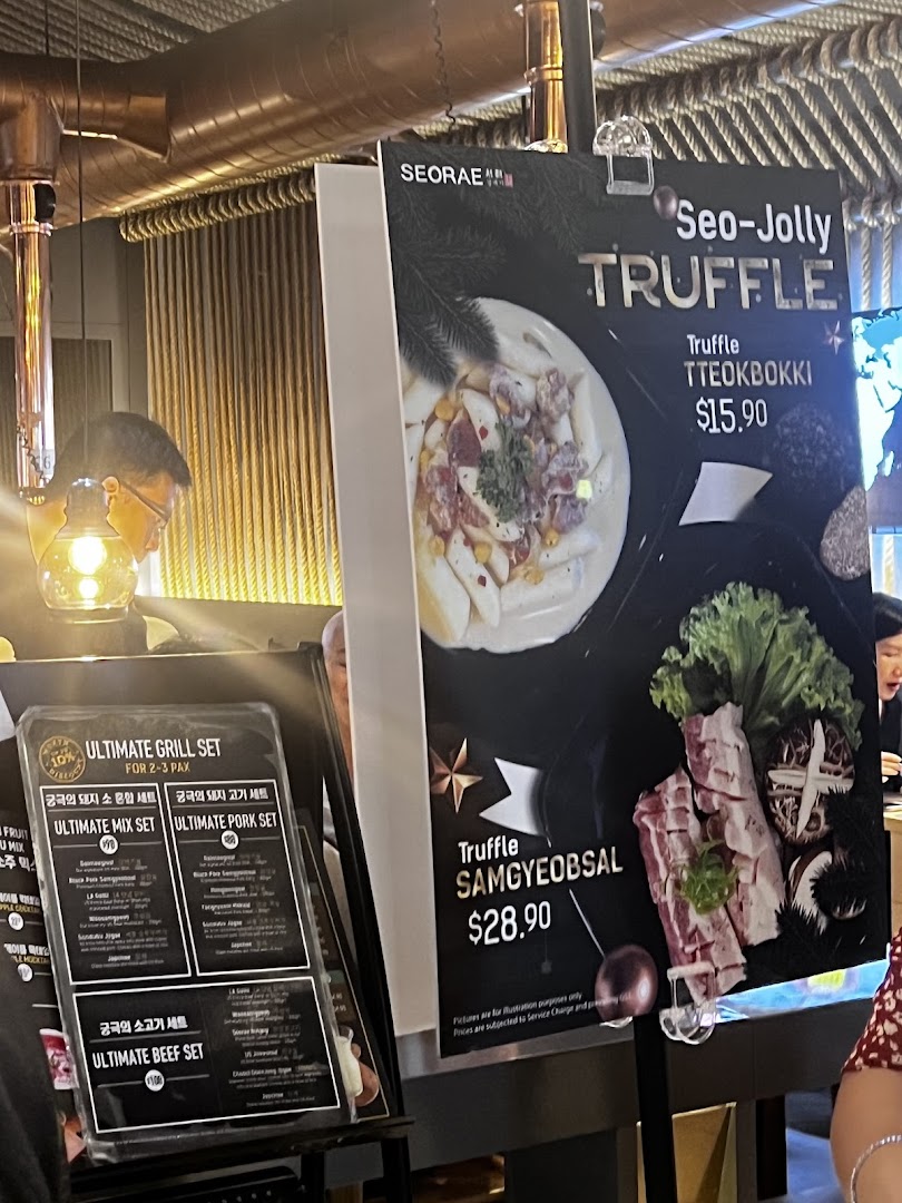 Image shows large menu displays for truffle tteokbokki and samgyeobsal, alongside a smaller menu for grill sets.