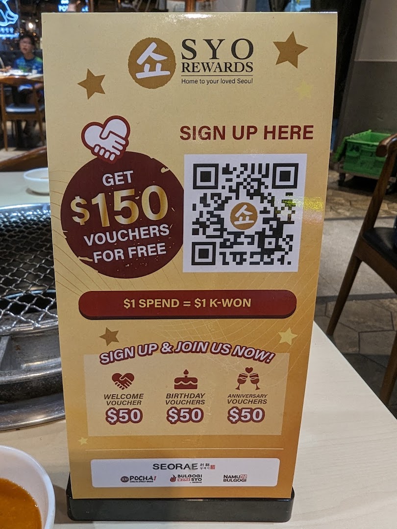 A promotional stand for SYO Rewards offering $150 in vouchers for free upon sign-up.