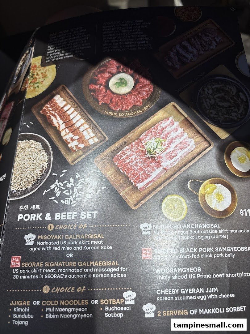 A menu page from Seorae Jib showcasing Korean BBQ meats like pork and beef sets, along with various side dish options.