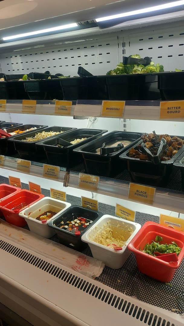 A vibrant display of fresh vegetables, mushrooms, and various condiments for a customizable meal.