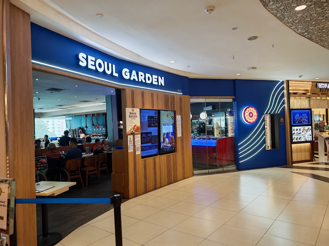 The brightly lit entrance of Seoul Garden at Tampines Mall, showcasing its inviting facade and digital promotions.