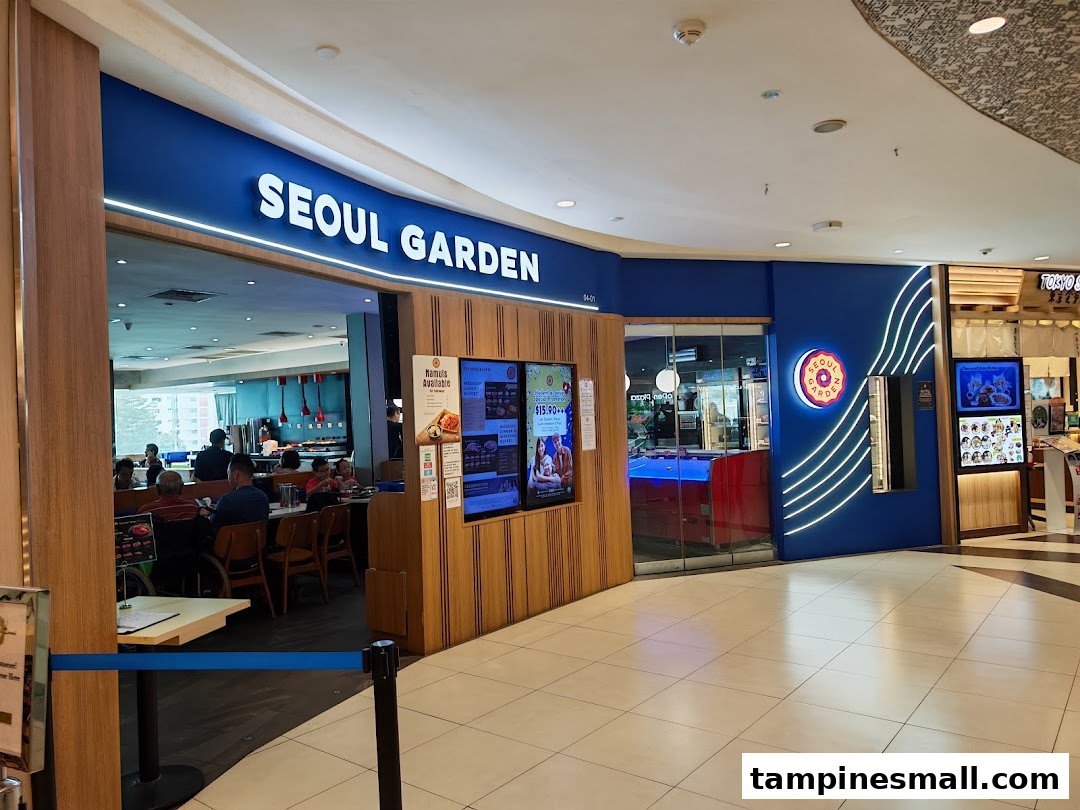 The brightly lit entrance of Seoul Garden at Tampines Mall, showcasing its inviting facade and digital promotions.