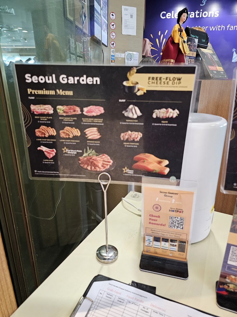 A display board showcasing Seoul Garden's premium menu items and special offers, including free-flow cheese dip.