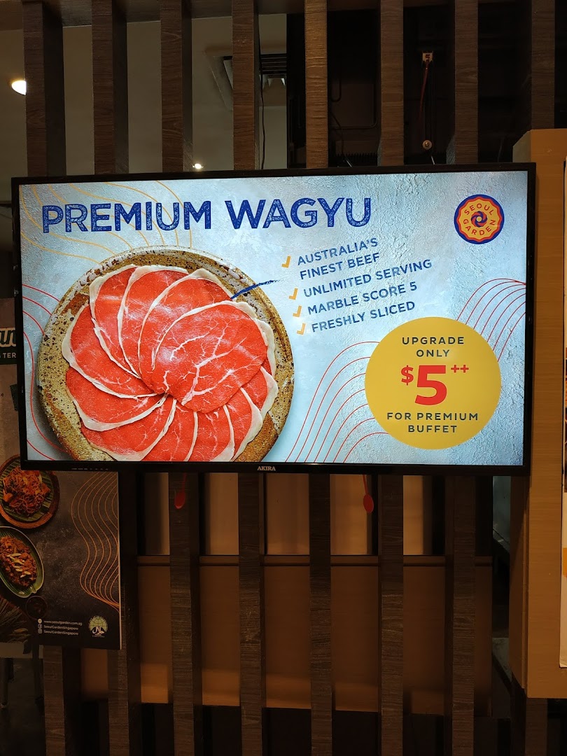 A digital display inside Seoul Garden advertising a Premium Wagyu beef upgrade for their buffet.