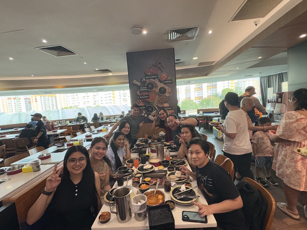 A lively group of friends enjoying a hotpot and grill meal together at Seoul Garden.