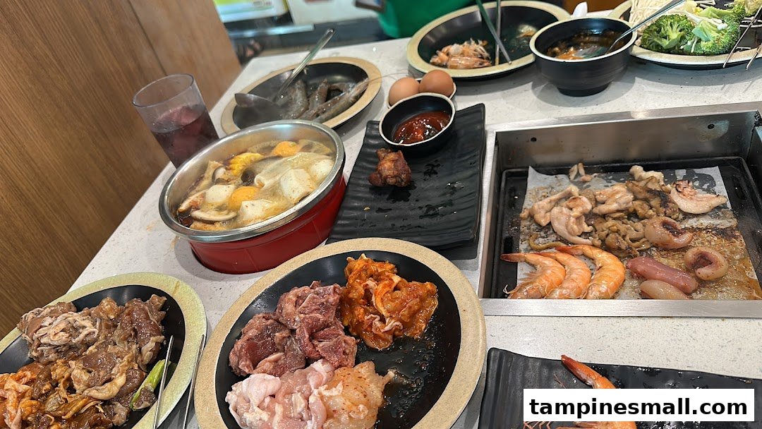 A table laden with raw meats, seafood, and vegetables for a hotpot and grill buffet experience.