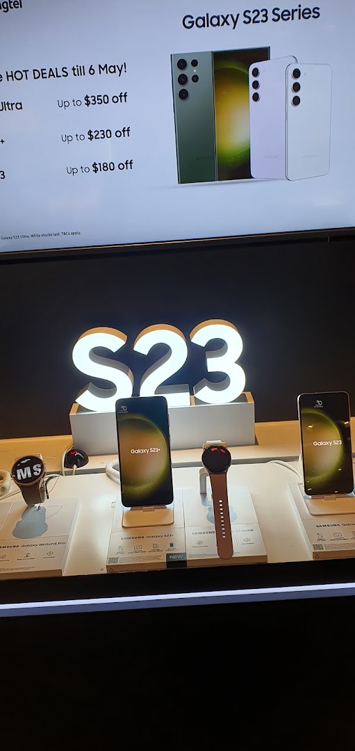 An in-store display showcasing Samsung Galaxy S23 series phones and smartwatches with promotional offers.