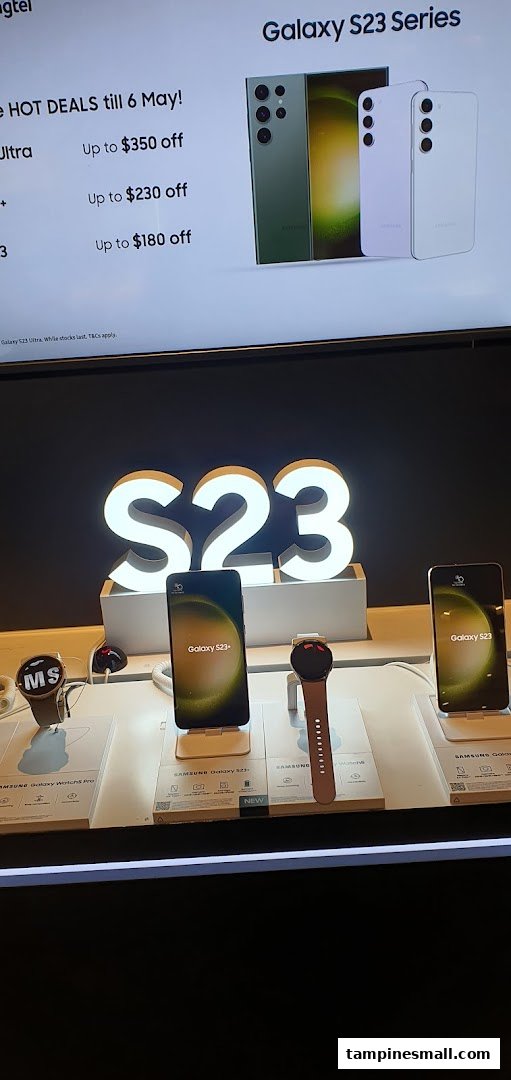 An in-store display showcasing Samsung Galaxy S23 series phones and smartwatches with promotional offers.