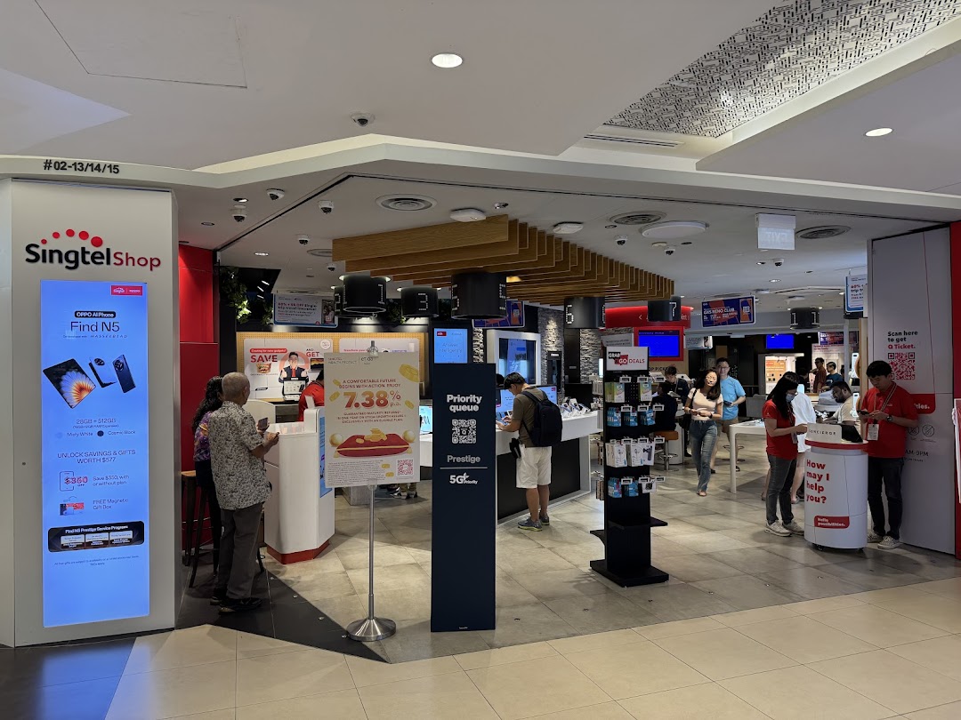 View of the Singtel Shop interior with customers browsing mobile devices and staff assisting.