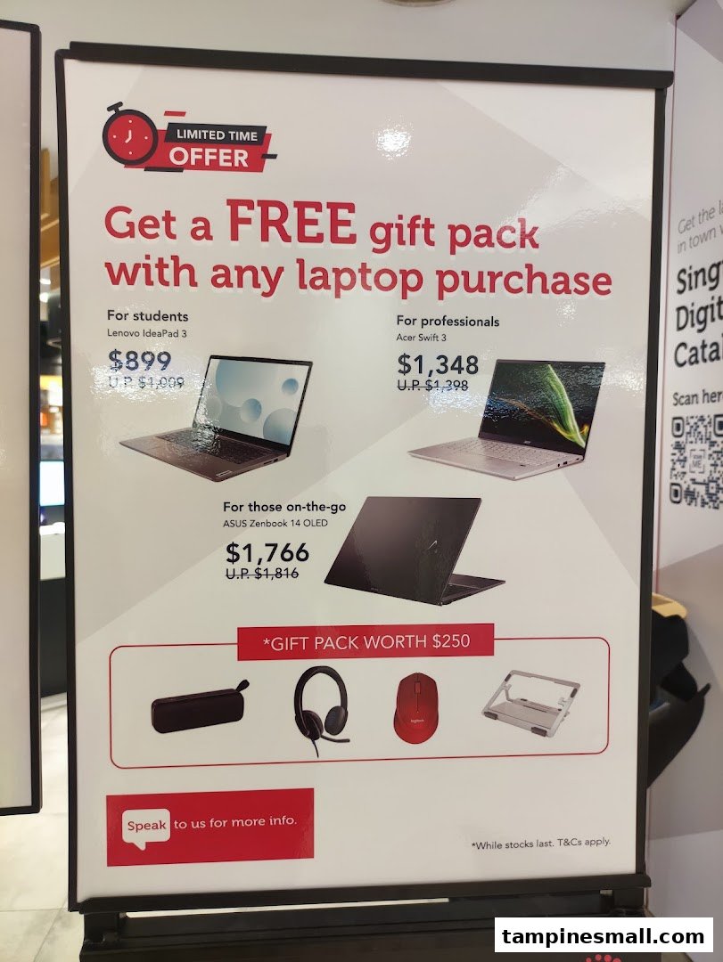 A promotional display offering a free gift pack with laptop purchases, featuring various models and prices.