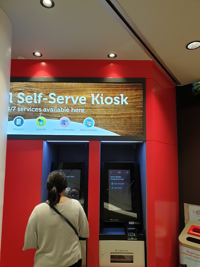 A customer uses a Singtel self-serve kiosk for various mobile services.