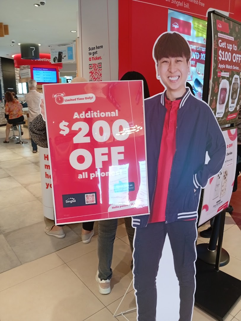 Interior view of a Singtel shop featuring promotional displays for phone and Apple Watch discounts.