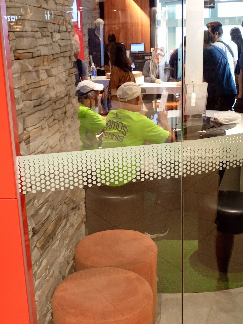 Customers engage with staff inside the Singtel Shop, showcasing active service and consultation areas.
