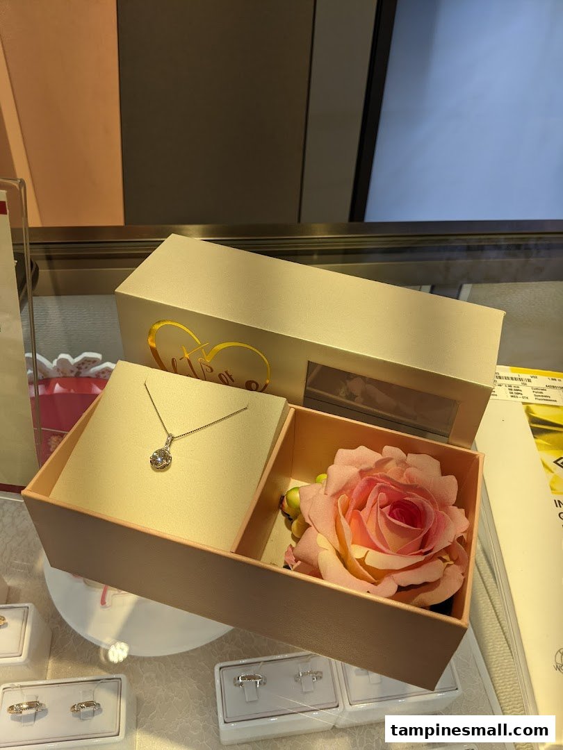 A beautiful diamond necklace and a rose displayed in a gift box, showcasing elegant jewelry.