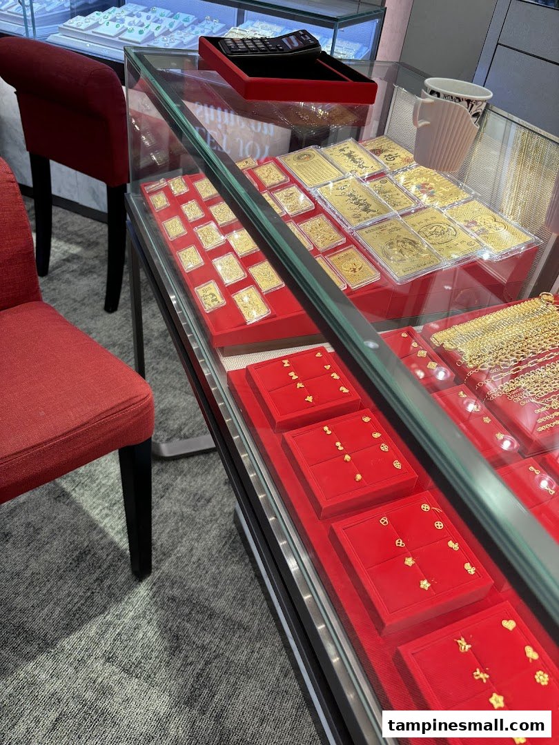 A display case at SK Gold showcasing an array of intricate gold jewelry and collectible gold bars.