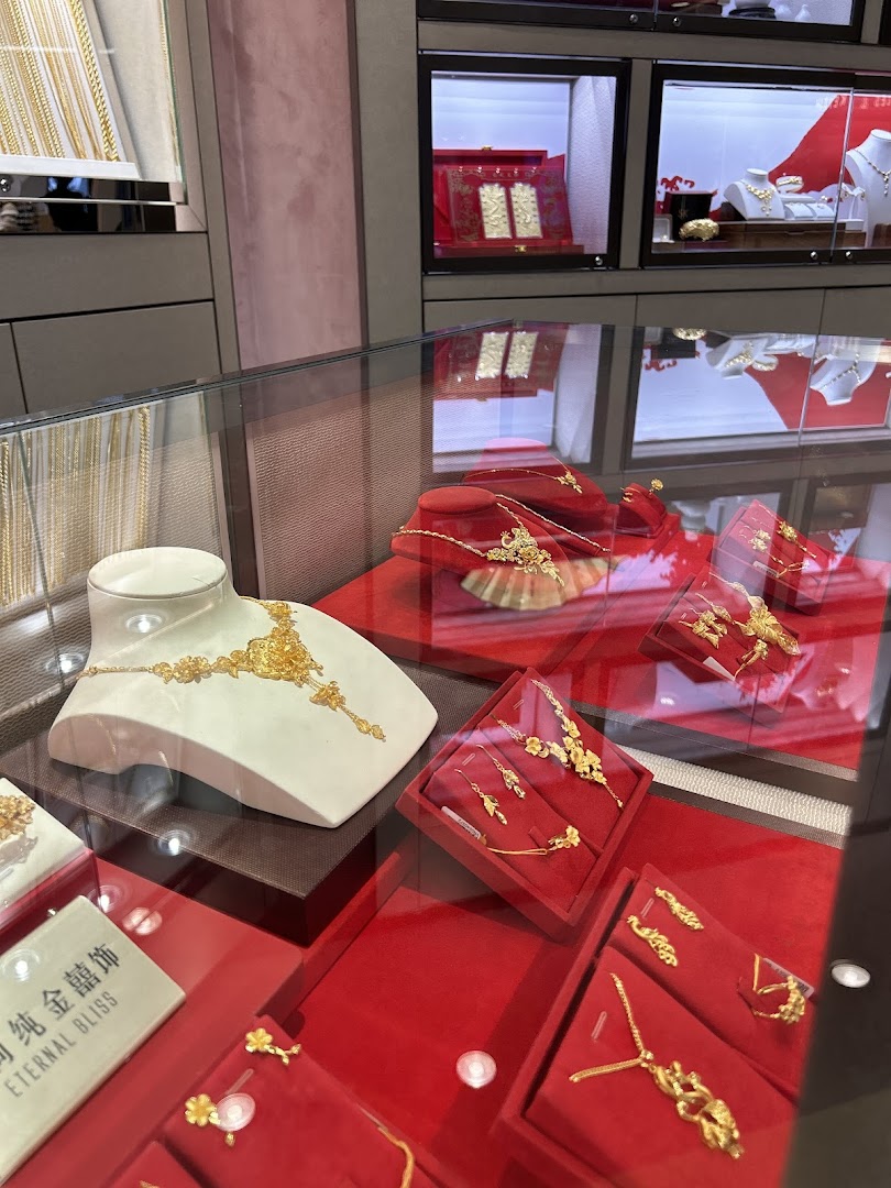 A close-up view of intricate gold jewelry displayed in glass cases at SK Gold.