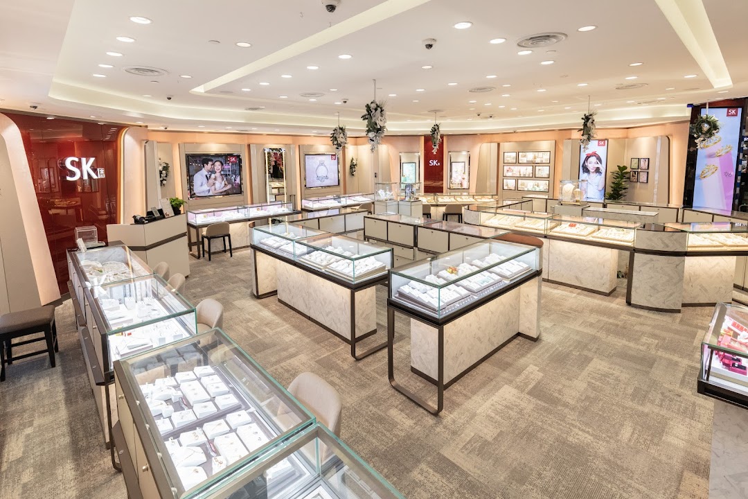A wide view of the SK Gold jewelry store interior, showcasing numerous illuminated display cases.