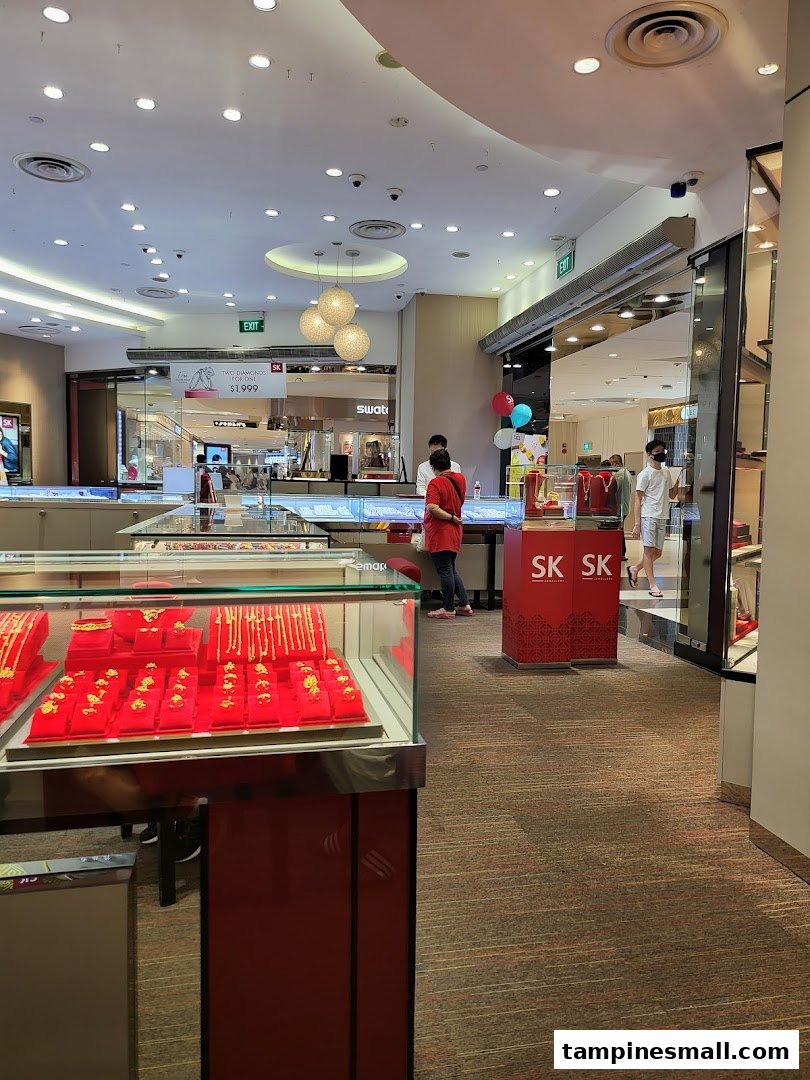Interior view of SK Jewellery showcasing gold jewelry displays and customers browsing.