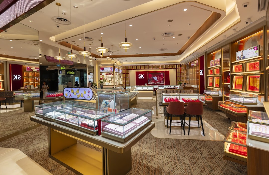 A brightly lit interior of SK Jewellery, showcasing numerous display cases filled with exquisite jewelry.